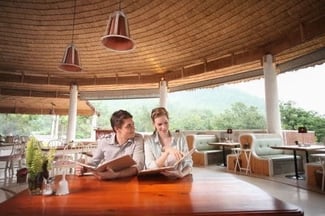happy couple reading high quality restaurant menu