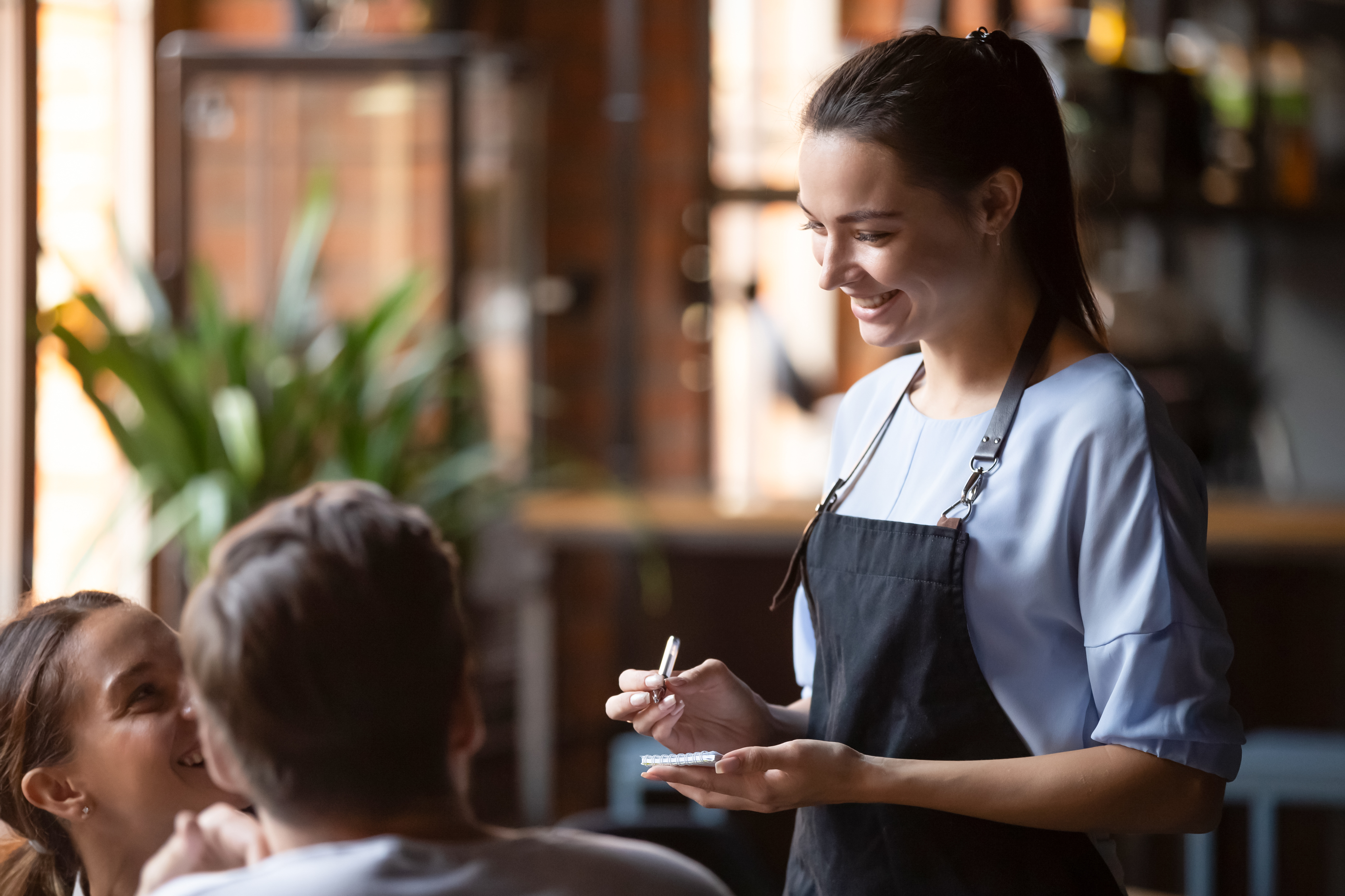 Happy Waitress with Customers