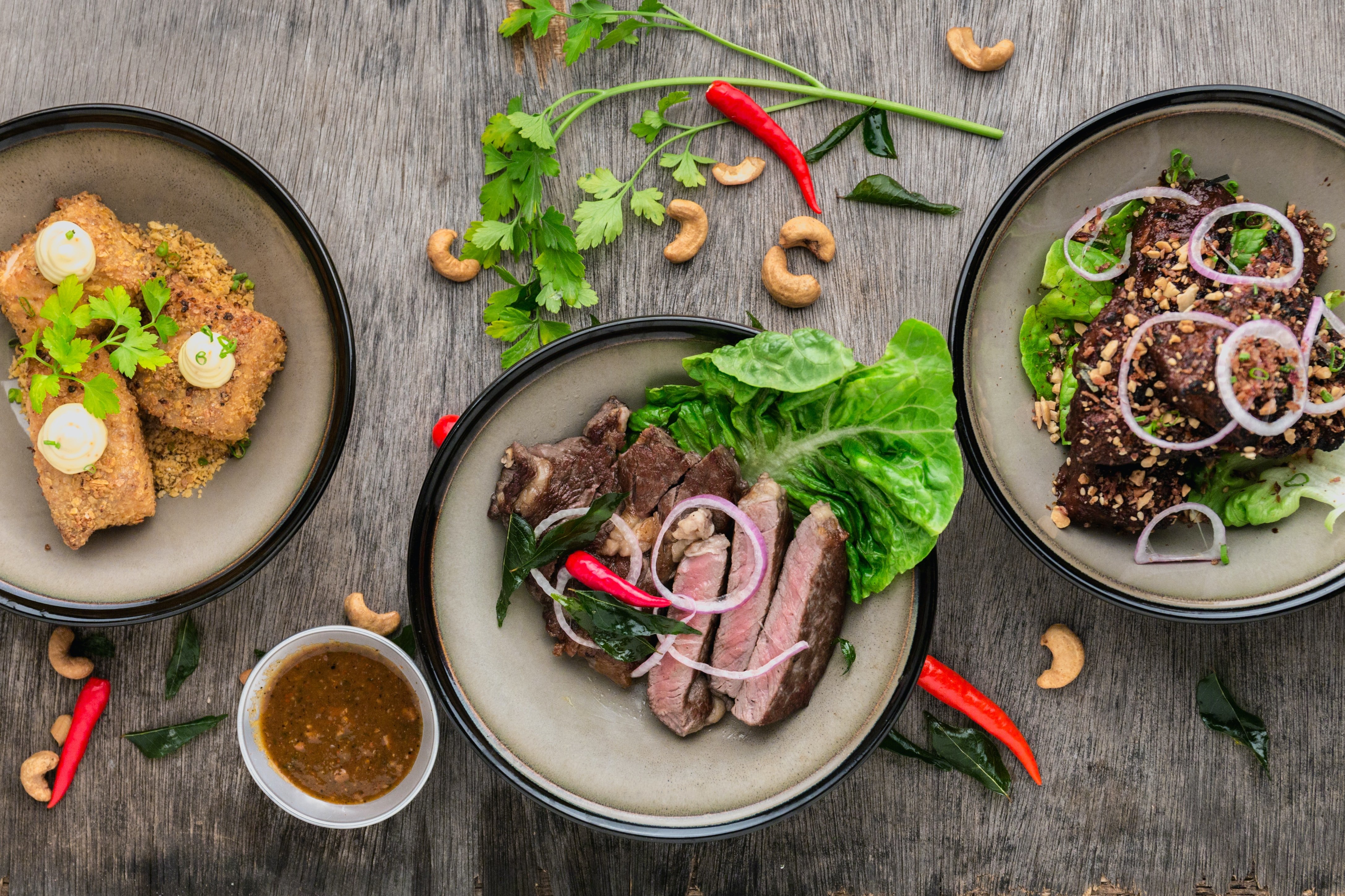 Three plates of food on a table displaying actual vs. theoretical food cost variance