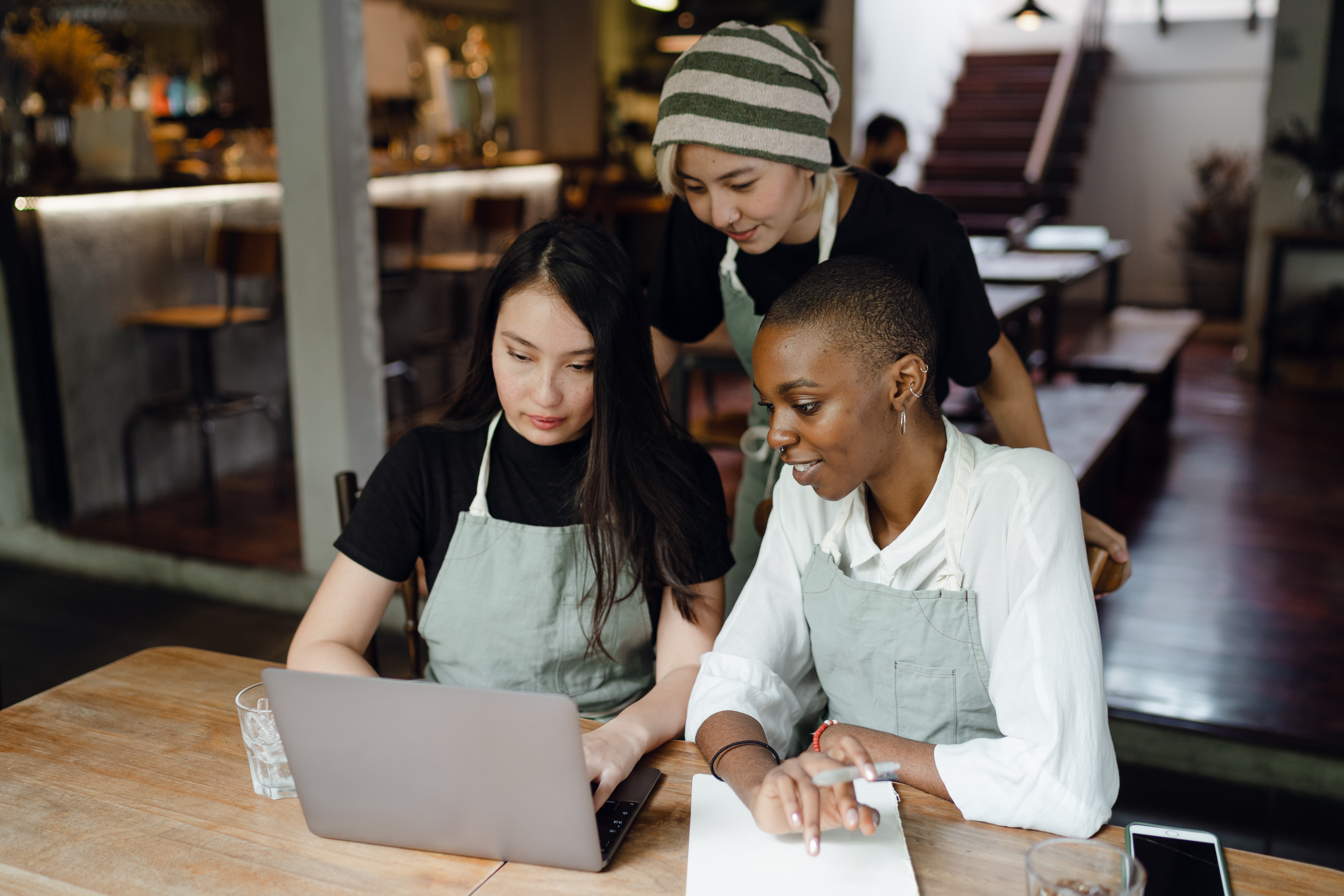 Three Restaurant Employees Using Labor Management Software