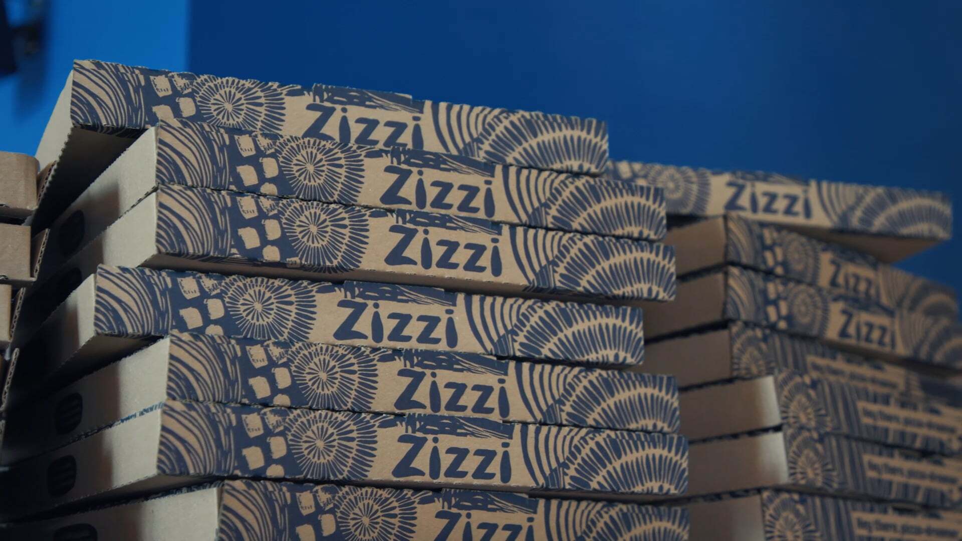 A stack of Zizzi's pizza boxes.